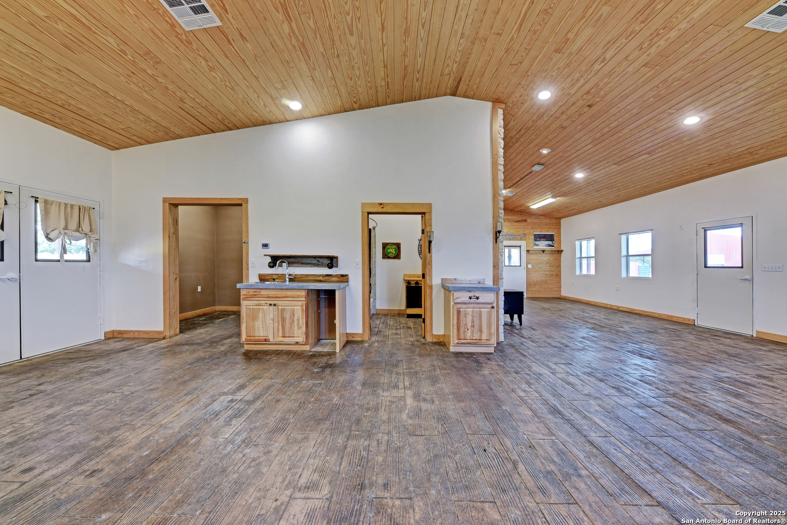 9560 Old Colony Line Road Dale, TX 78616 - Photo 29 of 41 a view of empty room with wooden floor and kitchen
