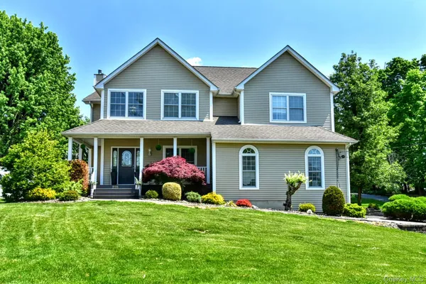 a front view of a house with a garden and plants