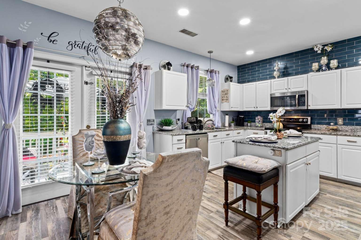 7828 Dunoon Lane Charlotte, NC 28269 - Photo 12 of 39 a kitchen with stainless steel appliances granite countertop a stove refrigerator sink and cabinets