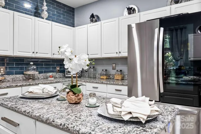 a kitchen with sink refrigerator and cabinets