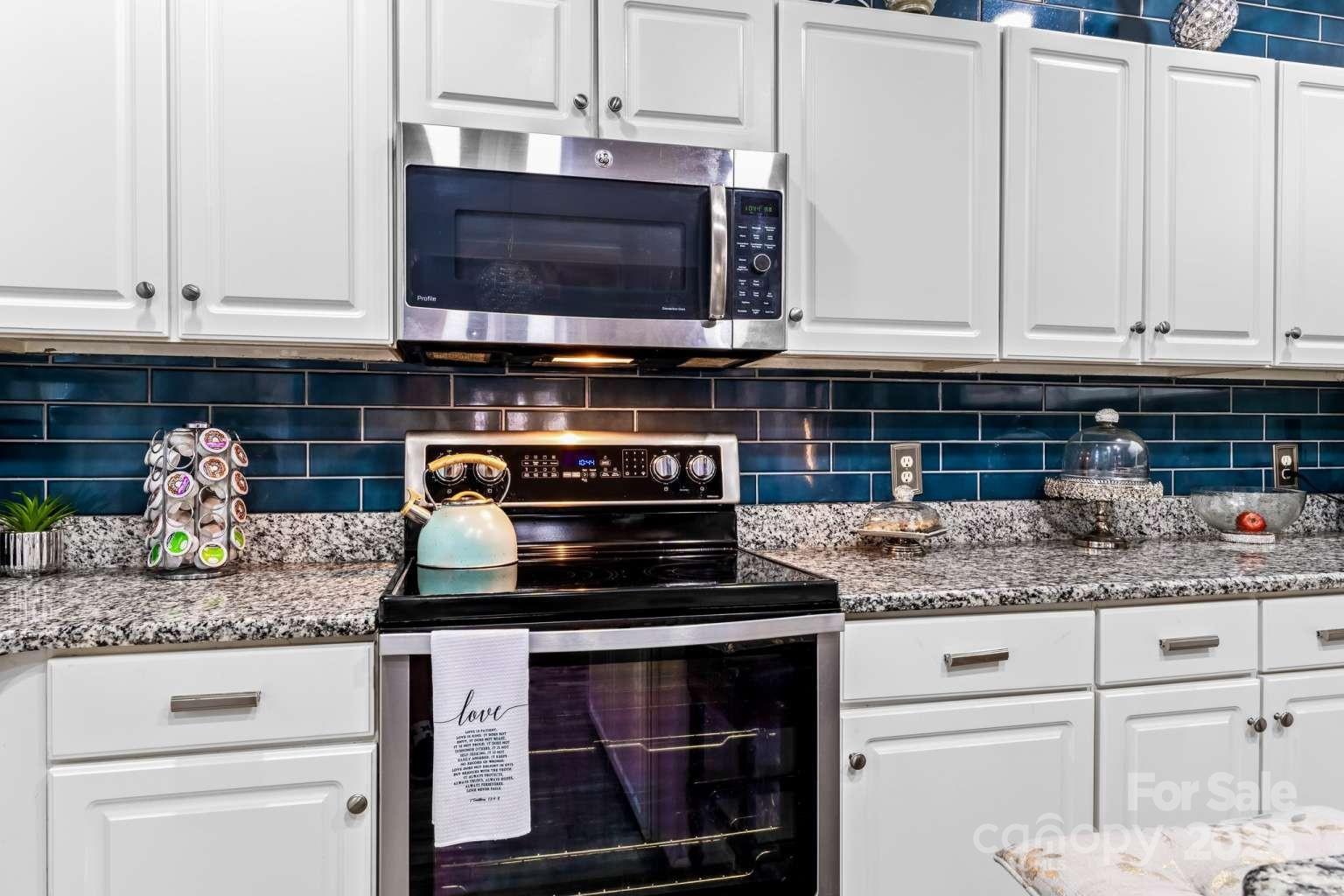 7828 Dunoon Lane Charlotte, NC 28269 - Photo 17 of 39 a kitchen with granite countertop a stove and a sink