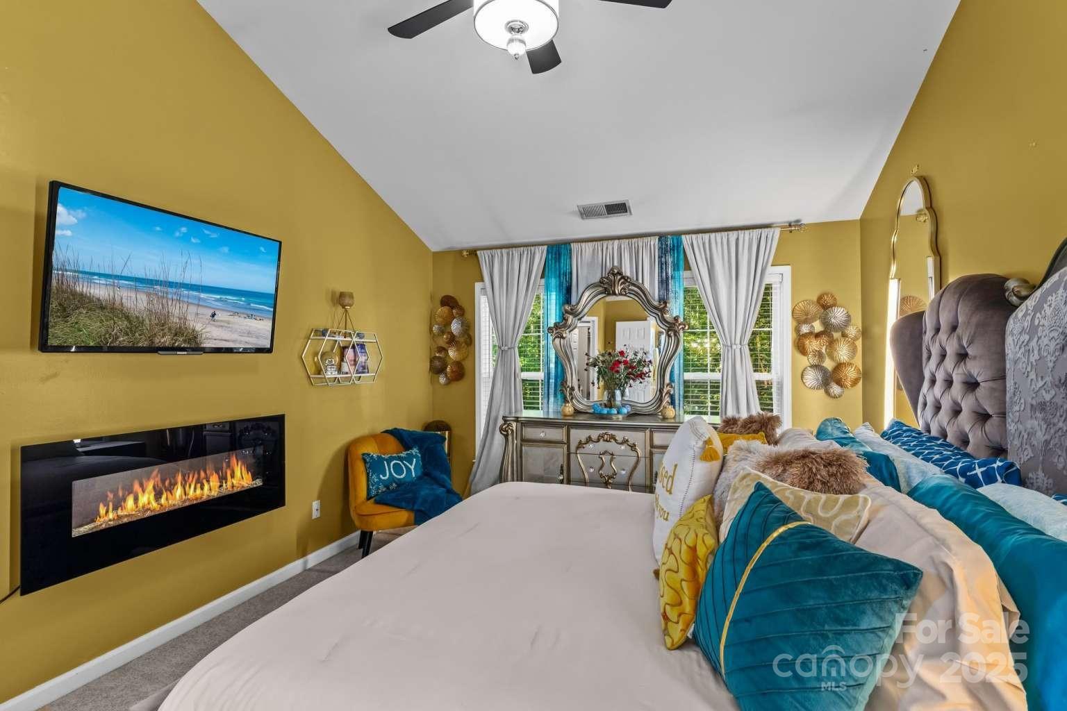 7828 Dunoon Lane Charlotte, NC 28269 - Photo 20 of 39 a bed room with a bed and a television