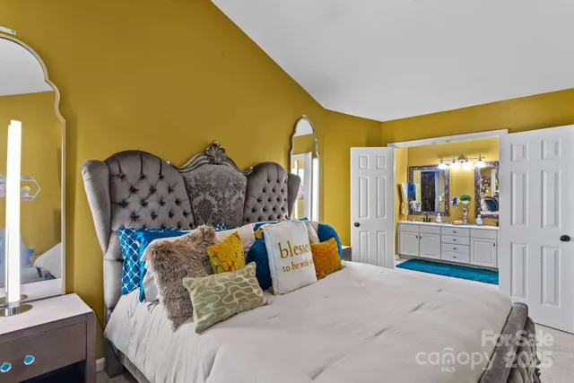 a bedroom with a bed and dresser with mirror