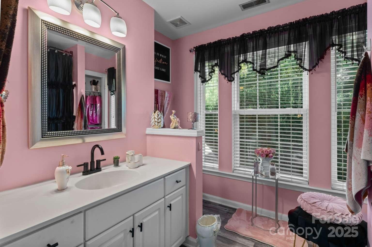 7828 Dunoon Lane Charlotte, NC 28269 - Photo 26 of 39 a bathroom with a sink and a mirror