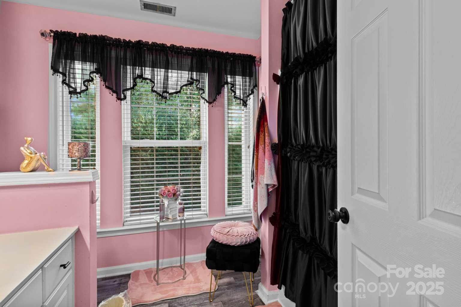 7828 Dunoon Lane Charlotte, NC 28269 - Photo 27 of 39 a view of walk in closet with clothes and shoes