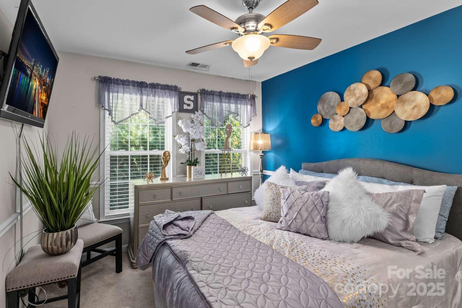 7828 Dunoon Lane Charlotte, NC 28269 - Photo 30 of 39 a bedroom with a bed and dresser