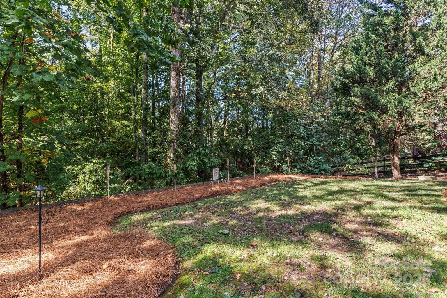 7828 Dunoon Lane Charlotte, NC 28269 - Photo 34 of 39 a view of a yard with a tree