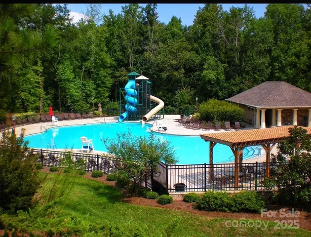 a view of a swimming pool with an outdoor space and seating area