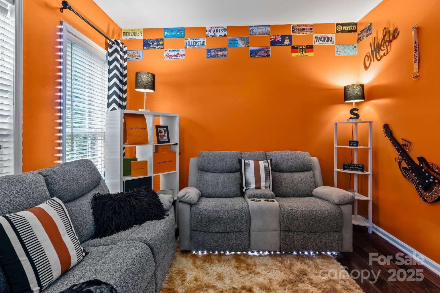 7828 Dunoon Lane Charlotte, NC 28269 - Photo 5 of 39 a blue couch sitting in front of a couch