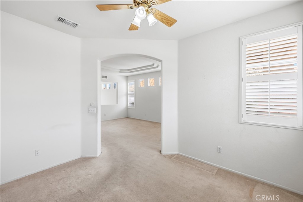 1961 Riviera Avenue Banning, CA 92220 - Photo 21 of 60 an empty room with a fan and a window