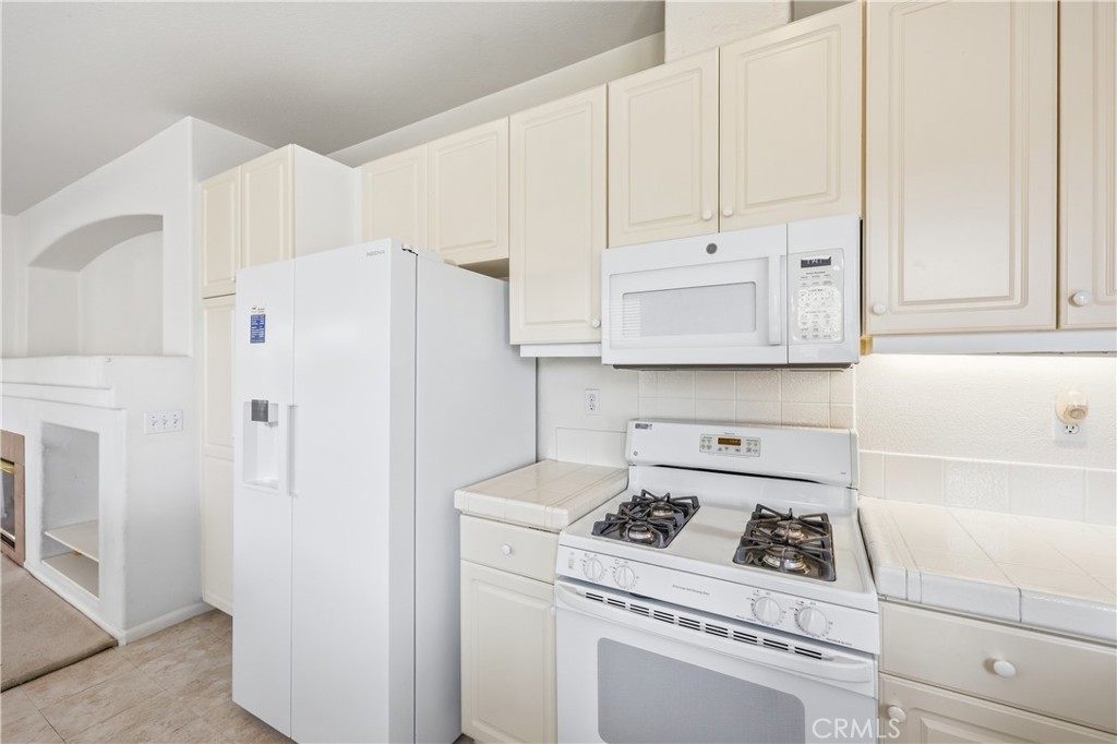 1961 Riviera Avenue Banning, CA 92220 - Photo 35 of 60 a kitchen with stainless steel appliances white cabinets and a stove