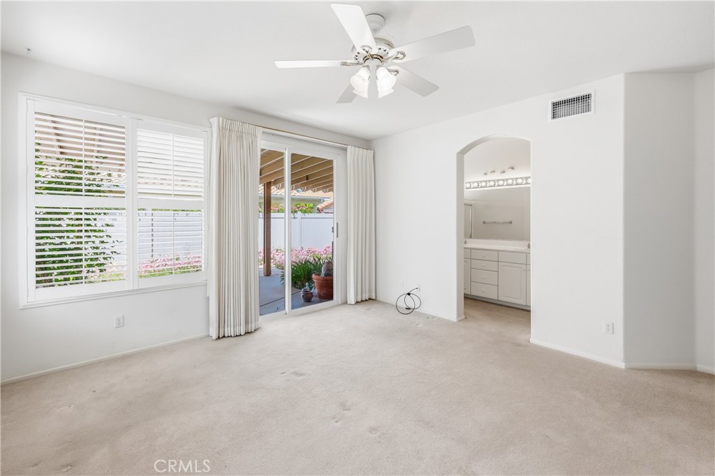 1961 Riviera Avenue Banning, CA 92220 - Photo 43 of 60 an empty room with chandelier fan and windows