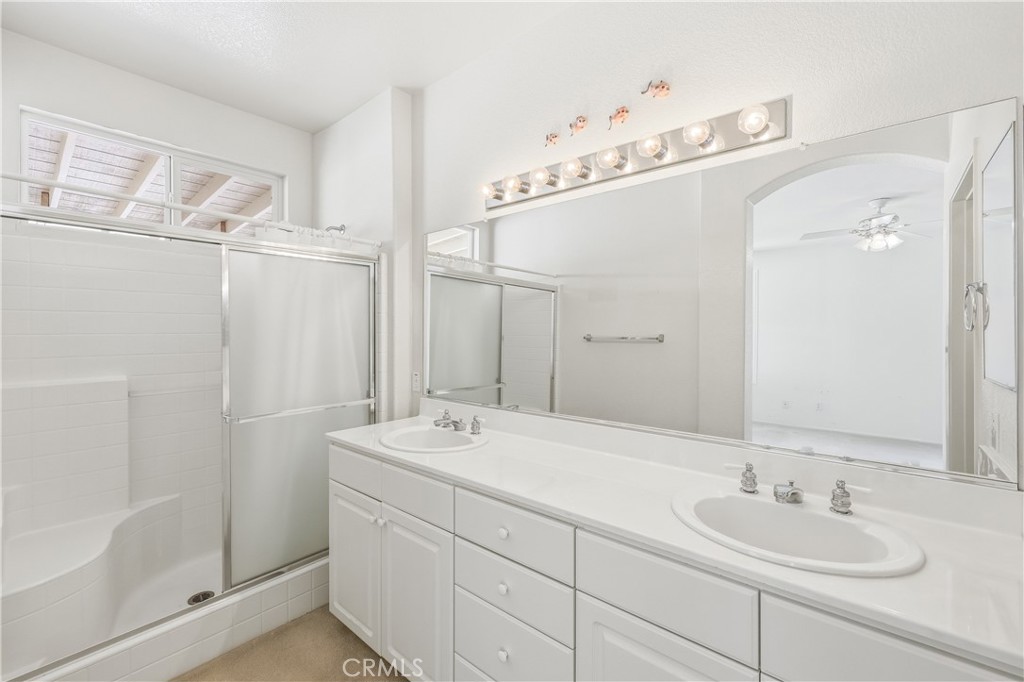 1961 Riviera Avenue Banning, CA 92220 - Photo 46 of 60 a bathroom with a double vanity sink mirror and shower