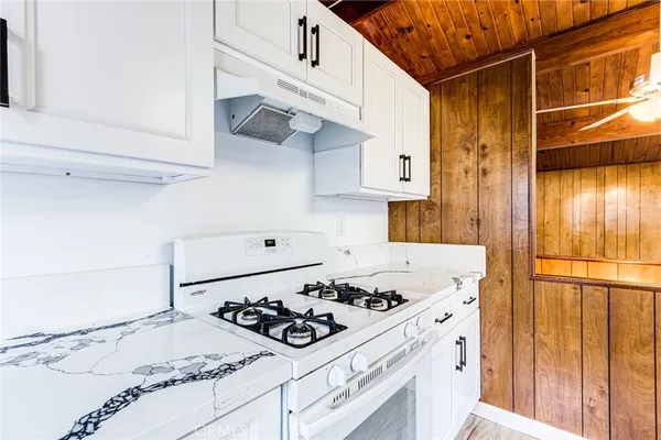 a kitchen with a stove and a refrigerator