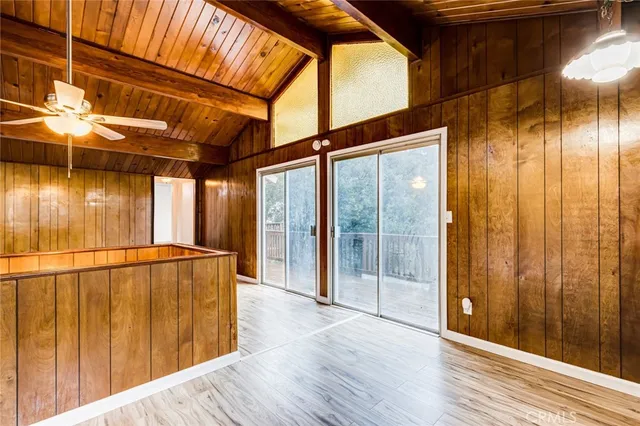 a view of a porch with wooden floor and door