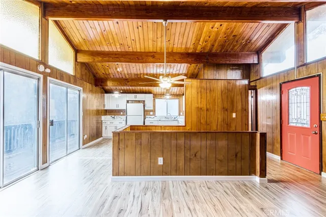 a view of a room with wooden floor