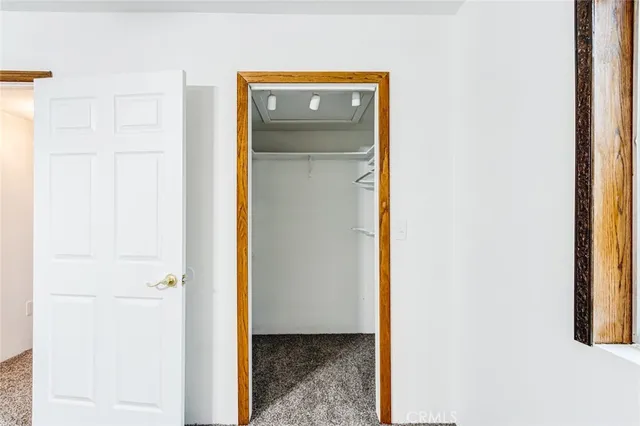 a view of a bathroom with a door and a mirror