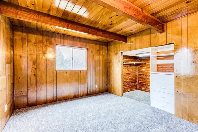 a view of an empty room with wooden walls