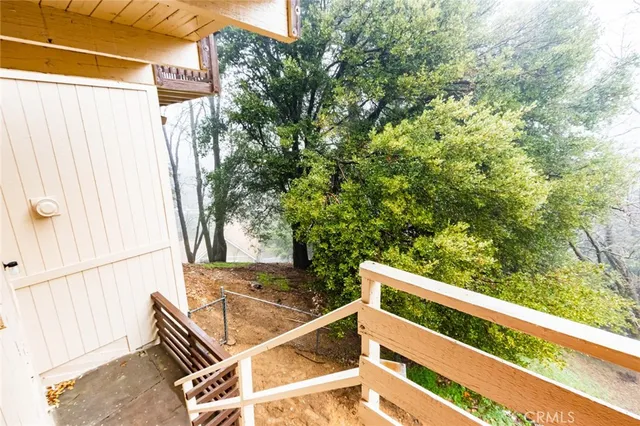 a view of backyard with green space and wooden fence