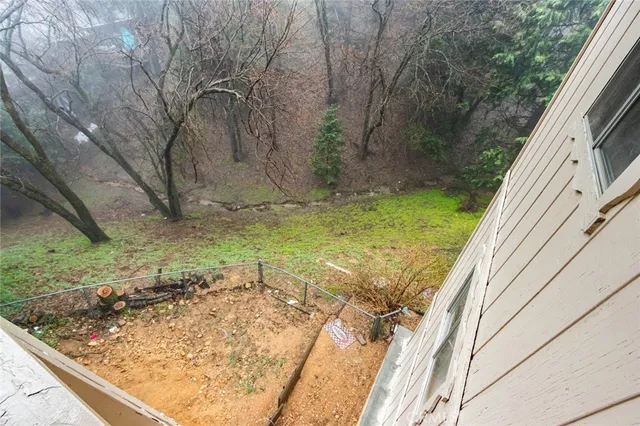 a view of a backyard with wooden fence
