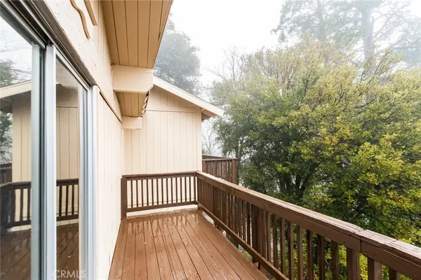 a view of balcony with wooden floor and fence