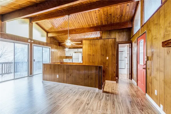 a view of a room with wooden floor and iron stairs