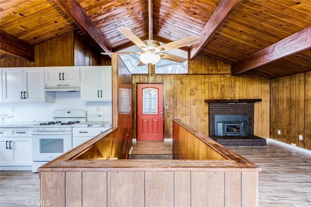 a kitchen with stainless steel appliances granite countertop a stove and a wooden cabinets