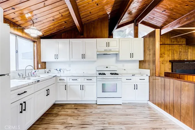 a kitchen with stainless steel appliances granite countertop a sink and cabinets