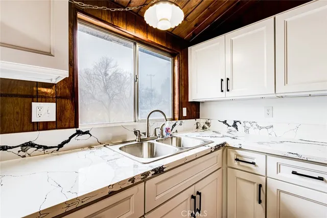 a kitchen with a sink cabinets and appliances