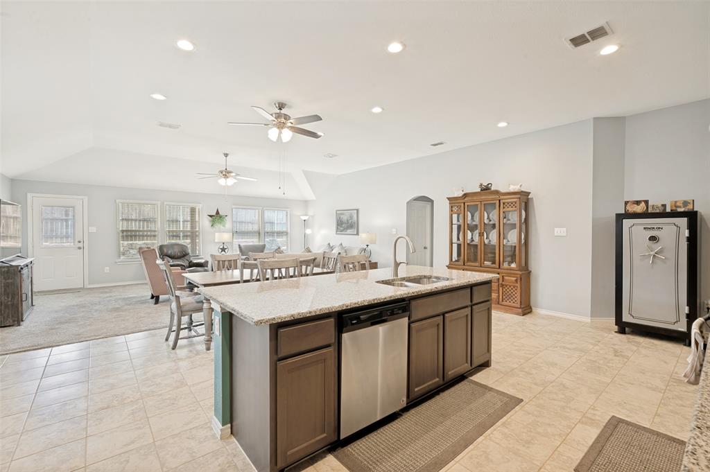 3905 Bridle Path Lane Sanger, TX 76266 - Photo 4 of 26 a view of a kitchen with kitchen island a sink a stove a dining table and chairs