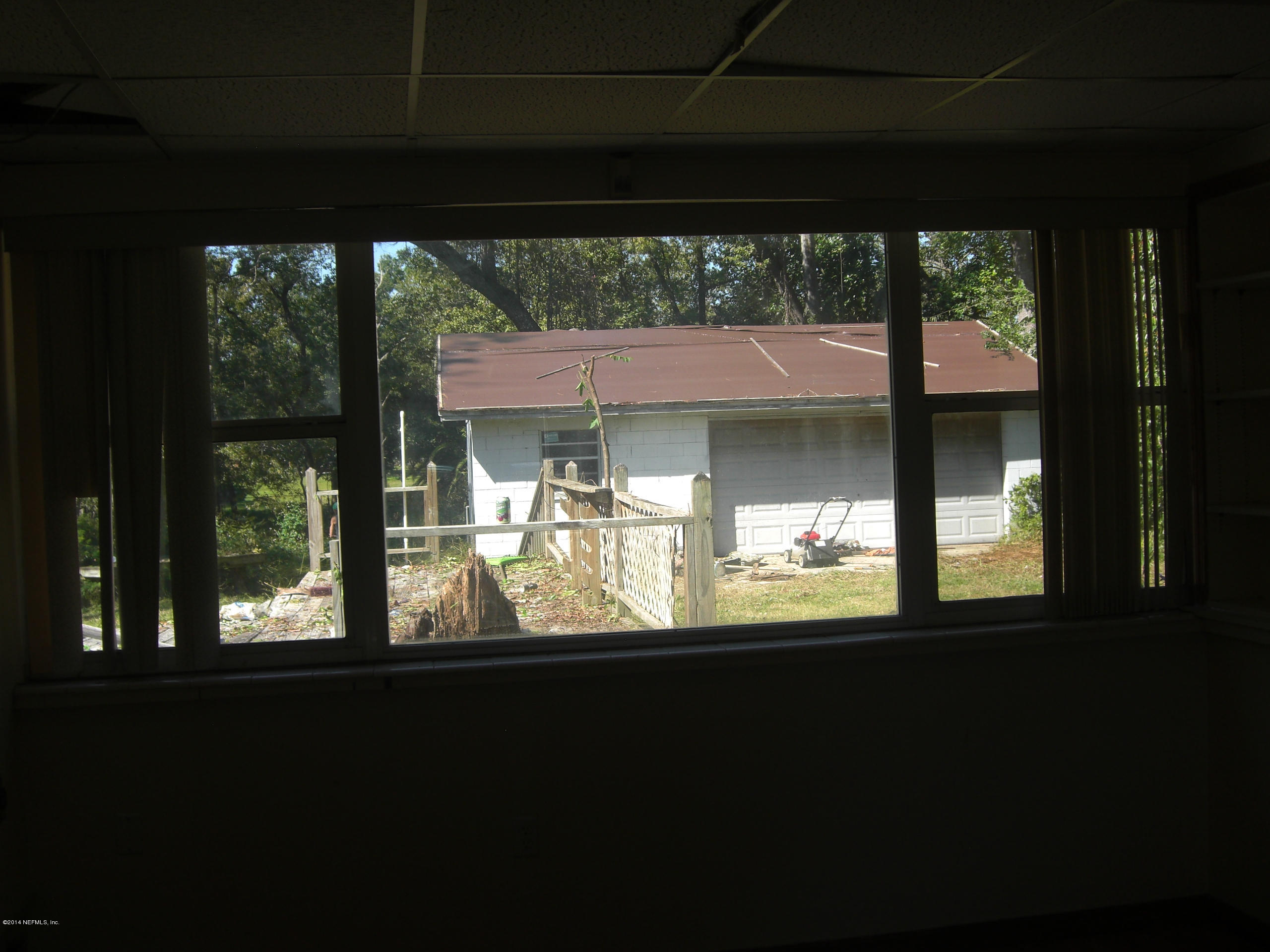 10586 Rutgers Road Jacksonville, FL 32218 - Photo 36 of 50 a view of a porch and a floor to ceiling window