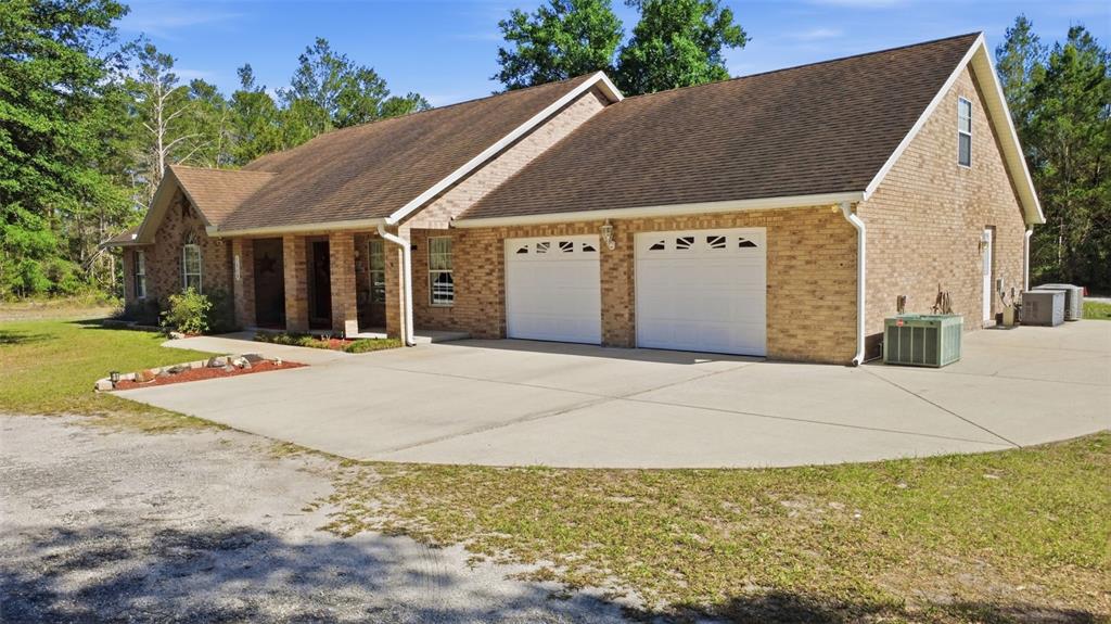 1640 Red Dog Road De Leon Springs, FL 32130 - Photo 1 of 58 a view of a white house with a yard