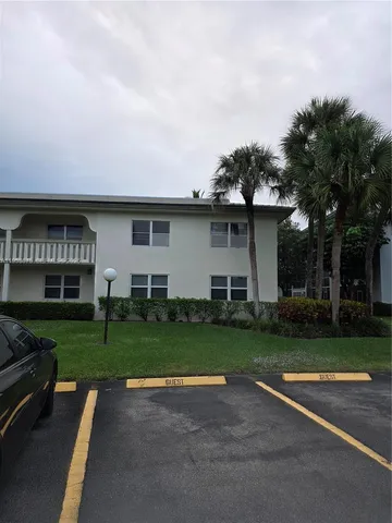 a view of backyard with outdoor seating and green space