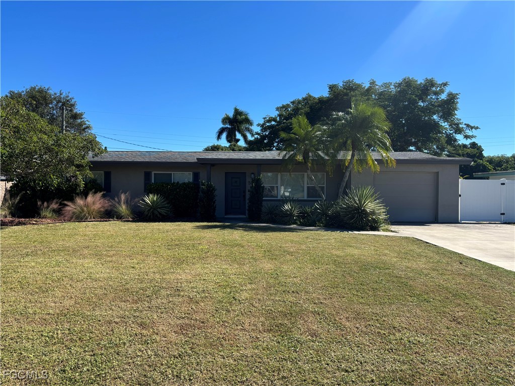 5521 Granada Road Fort Myers, FL 33919 - Photo 2 of 17 a front view of house with yard and green space