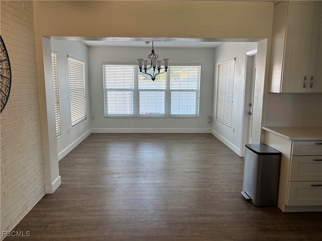 5521 Granada Road Fort Myers, FL 33919 - Photo 4 of 17 an empty room with wooden floor and windows