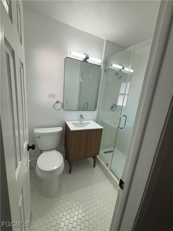 5521 Granada Road Fort Myers, FL 33919 - Photo 8 of 17 a bathroom with a sink toilet mirror and shower