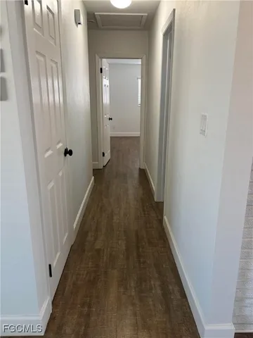 a view of a hallway with a wooden floor