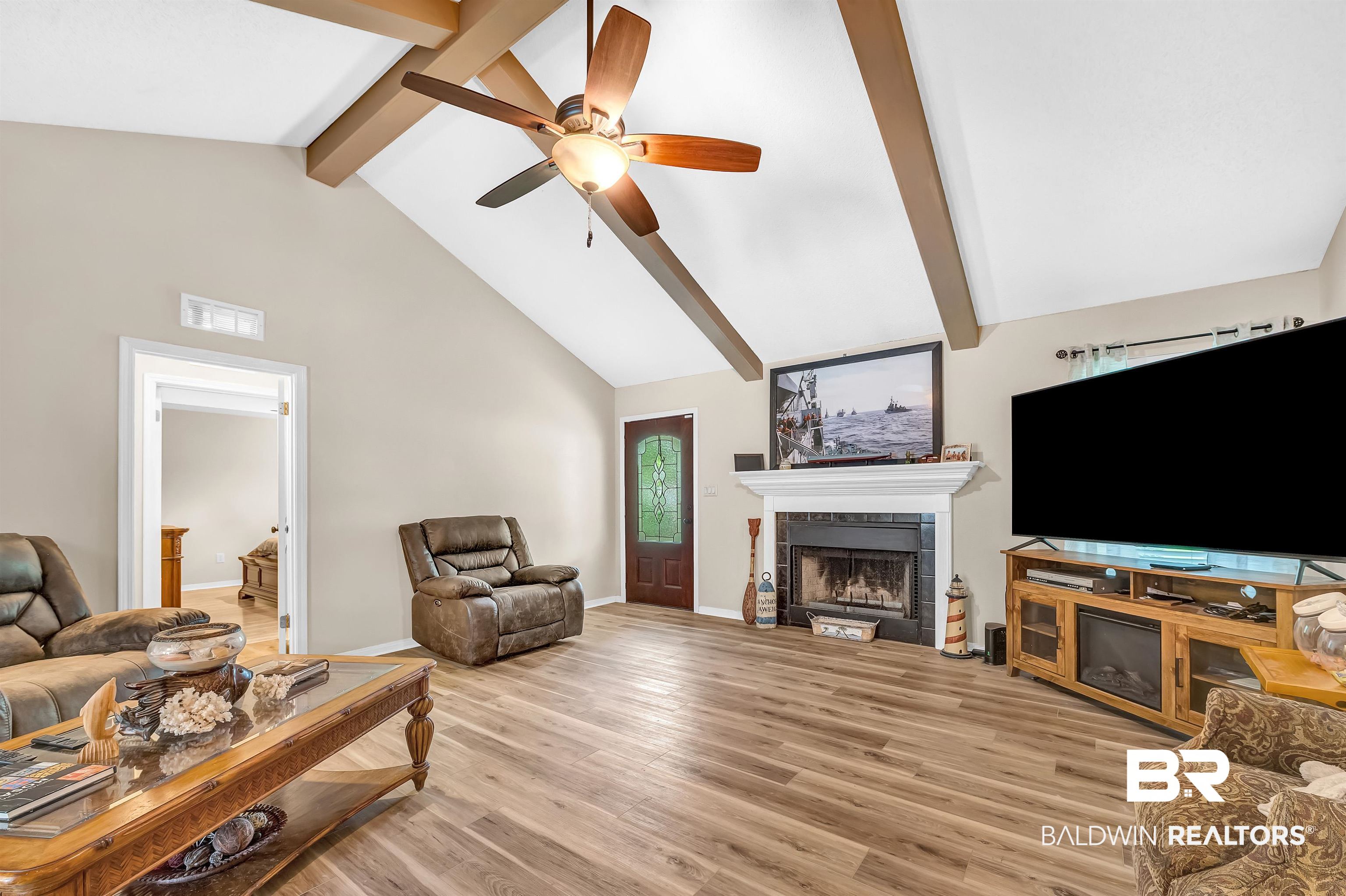 24551 Wolf Bay Drive Foley, AL 36535 - Photo 21 of 59 Living room featuring beamed ceiling, a fireplace, high vaulted ceiling, ceiling fan, and light wood-style flooring