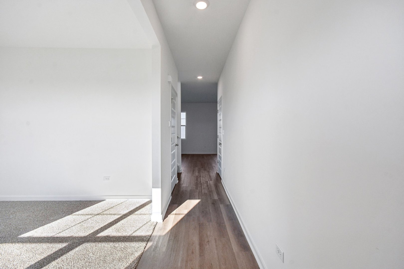 13712 Palmetto Drive Plainfield, IL 60544 - Photo 22 of 50 a view of a hallway with wooden floor and a carpet
