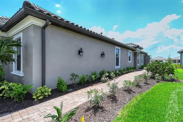 a backyard of a house with flower plants