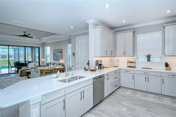 a kitchen with cabinets stainless steel appliances and sink