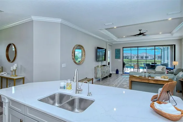 a kitchen with a sink cabinets and wooden floor