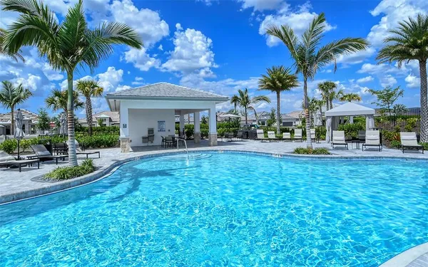 a swimming pool with outdoor seating and yard