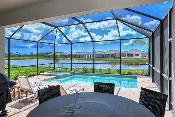 a room with pool table and chairs