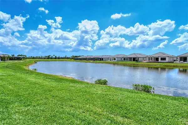 a view of a lake with houses in the back