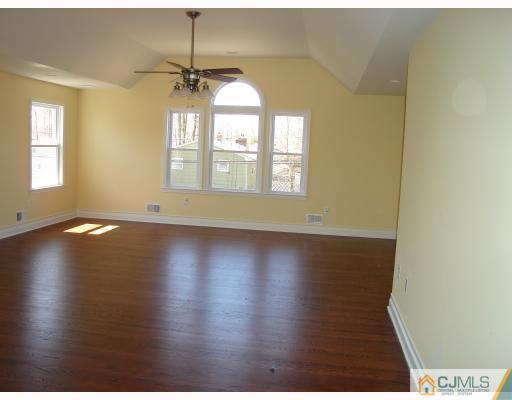12 Frances Road Edison, NJ 08820 - Photo 8 of 10 an empty room with wooden floor and windows