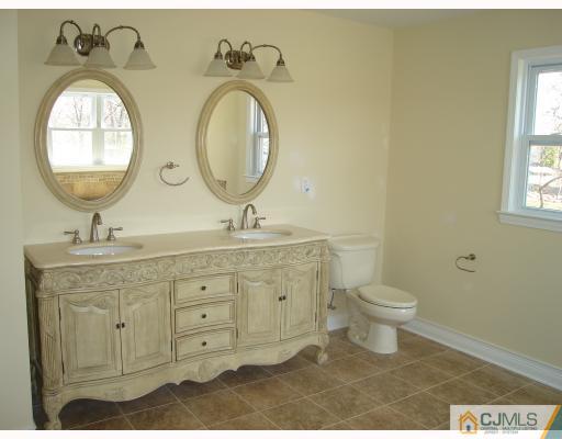 12 Frances Road Edison, NJ 08820 - Photo 9 of 10 a bathroom with a granite countertop toilet a sink and a mirror