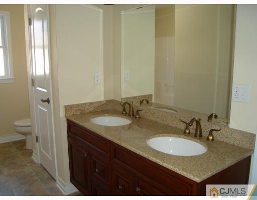 12 Frances Road Edison, NJ 08820 - Photo 10 of 10 a bathroom with a granite countertop sink and a mirror