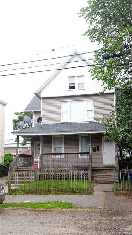39 5th Street Bridgeport, CT 06607 - Photo 1 of 1 a view of a white house with large windows and a yard