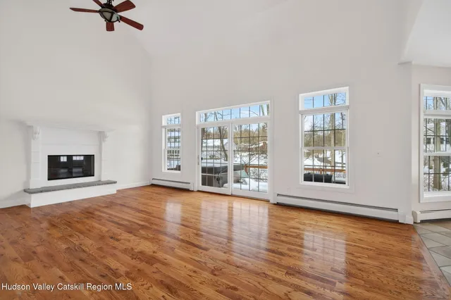 a bedroom with a bed and large window